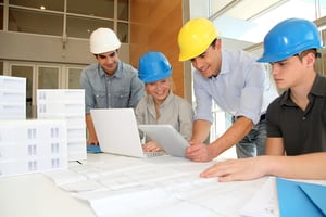 Educator with students in architecture working on electronic tablet-1