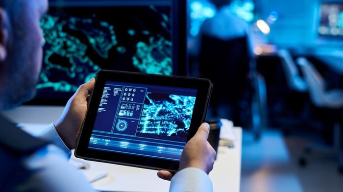 man holding tablet with digital data