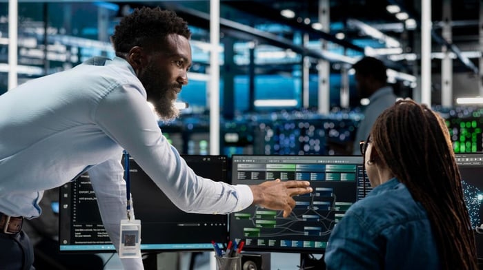 two colleagues viewing monitor