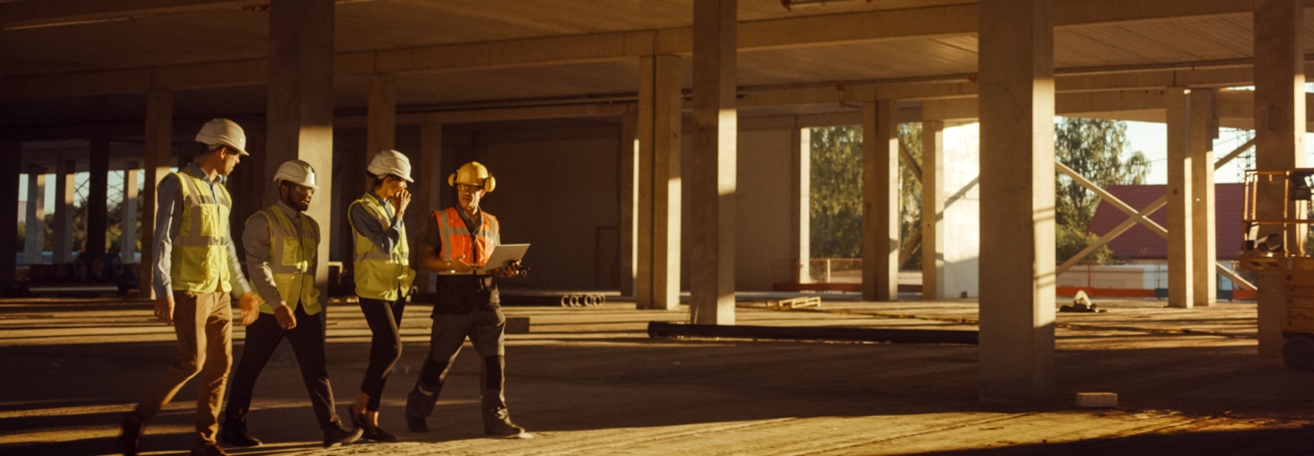 Diverse-Team-of-Specialists-Walk-Through-Garage-Level-of-Building-Construction-Project-Site-(desktop)